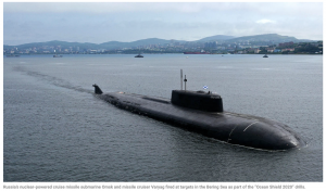 Russian nuclear submarine surfaces near Alaska and F-22 fighter jets intercept six aircraft as Putin holds major war games in the Bering Sea for first time since Soviet era.